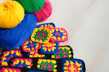 Knitted zigzag handmade ornaments and skeins of multi-colored threads.