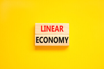 Linear economy symbol. Concept words Linear economy on beautiful wooden block. Beautiful yellow...