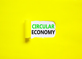 Circular economy symbol. Concept words Circular economy on beautiful white paper. Beautiful yellow background. Business circular economy concept. Copy space.