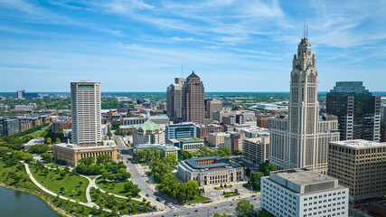 Fototapeta na wymiar Columbus Ohio aerial with cloudy blue skies and green park with walkways along river