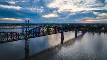 Aerial LGBTQ rainbow pride colors on bridge over Ohio River at sunset Kentucky