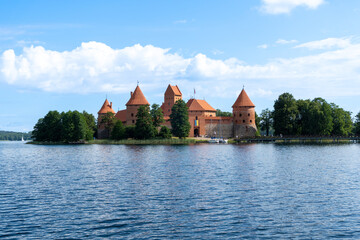 Naklejka na ściany i meble Trakai Castle in the middle of the lake, on a sunny summer day with some clouds.