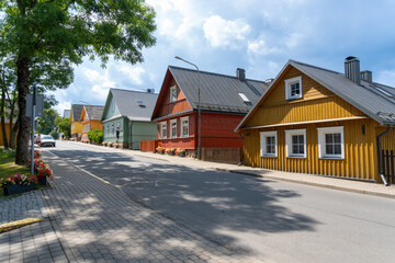 Small houses in the village of Trakai in Lithuania. Colored houses with blue sky with clouds.