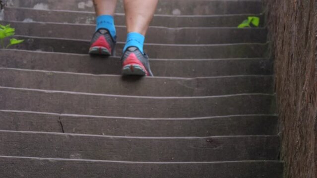 Human legs rise up on old trampled stone stairs up in the castle slow motion