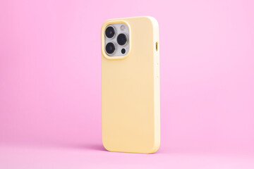 iPhone 15 Pro in yellow case back side view isolated on pink background, phone case mock up