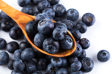 Fresh blueberries in wooden spoon