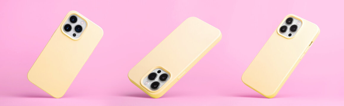 Set Of Three IPhone 15 Pro In Yellow Silicone Case Falling Down In Different Angles, Back View Isolated On Pink Background, Phone Case Mockup