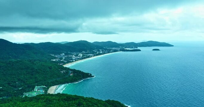 aerial view scenery green sea white beach and green forest at Freedom beach Patong Phuket. .aerial view many beautiful beaches in Phuket island..white waves slowly crept towards the shore.