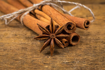 Close up of cinnamon sticks and star anise on wood