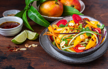 Spicy Thai Mango Salad featuring fresh flavors of cucumber, carrot and cilantro spicy, sweet and savory dressing.