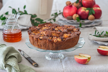 Apple cake with hazelnuts and cinnamon. Rosh hashanah jewish New Year holiday concept.