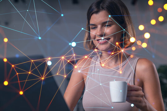 Thoughtful businesswoman in casual wear typing on laptop at office workplace with coffee cup. Concept of distant work, business, internet surfing, information technology. Social network hologram