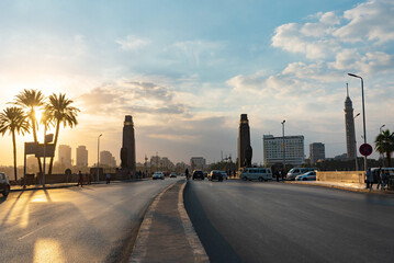 Qasr El Nil Bridge over the River Nile near Tahrih Square in Downtown Cairo cityscape at sunset...