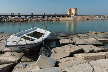 A boat on concrete blocks positioned as a defence against rising sea levels along the Corniche of...