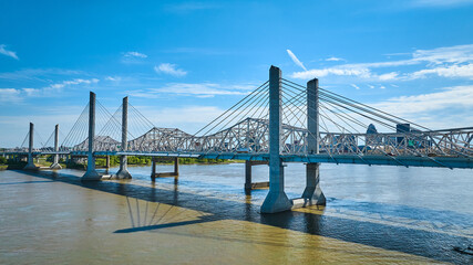Two suspension bridges over Ohio River in Louisville Kentucky partially cloudy aerial