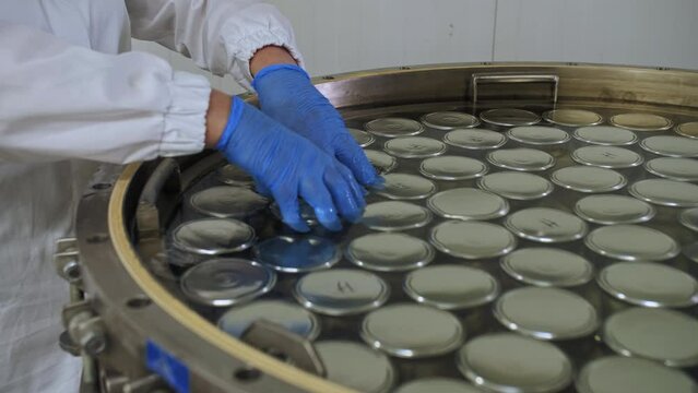 Loading cans of canned fish into an autoclave