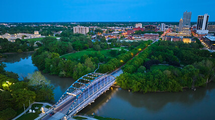 Aerial Martin Luther King Bridge downtown Fort Wayne aerial with park and buildings at dusk