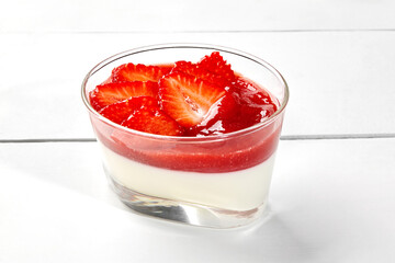 Panna cotta with strawberry and rhubarb coulis and fresh berries