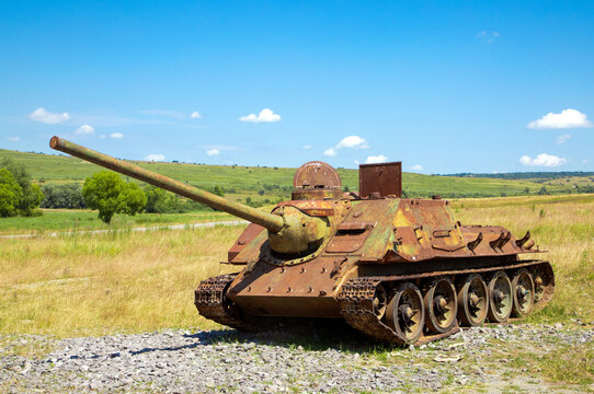 A close-up of an old Soviet tank abandoned in the field