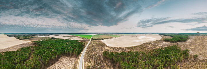 Aerial View Of Highway Road Through Deforestation Area Landscape. Green Pine Forest In Deforestation Zone. Top View Of Field And Forest Landscape. Drone View. Bird's Eye View