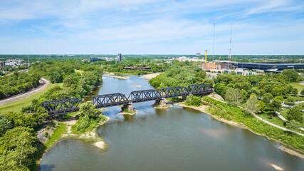 Old train bridge over river outside Columbus Ohio aerial