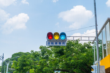 Japanese traffic lights and sign above scramble crossing in front of Tokyo station ,Japanese under the traffic light means "push button type.