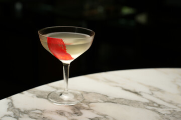 Red line cocktail glass on a marble bar counter