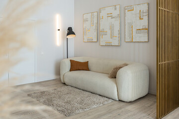 a soft comfortable sofa with a floor lamp is an open-plan apartment in a modern style with light walls and wooden floors and a stylish golden partition