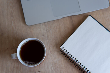 notebook and cup on wooden table