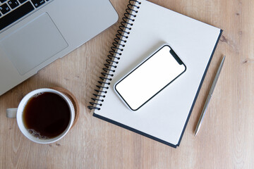 cup of coffee and notebook with phone