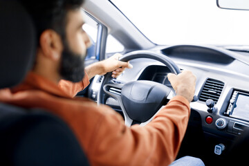 Naklejka premium Arabic Man Driver Driving Siting Inside Auto Holding Car Wheel