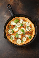 Sun baked tomato, goats cheese and courgette quiche served in cast iron pan with side salad