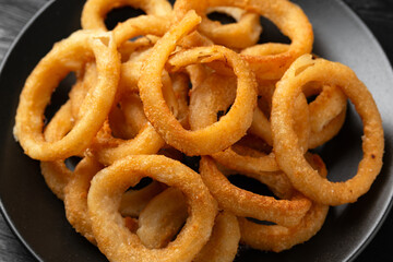 Crunchy Fried Battered onion rings on black plate