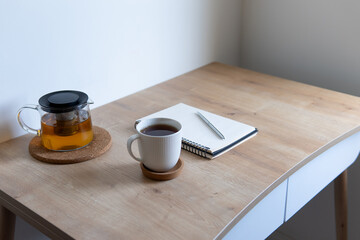 cup of coffee with notebook on the table
