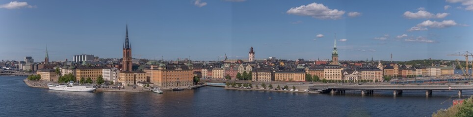 Fototapeta na wymiar Panorama, view from the board walk Monteliusvägen in the district Södermalm cliff Maria Berget, a sunny summer evening in Stockholm