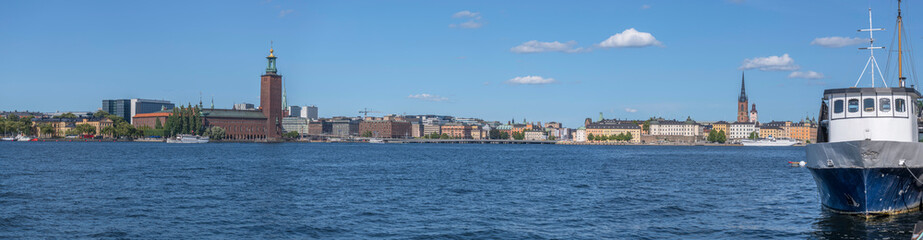 Fototapeta na wymiar Panorama, the Town City Hall, the down town and old town at the bay Riddarfjärden, a sunny summer day in Stockholm
