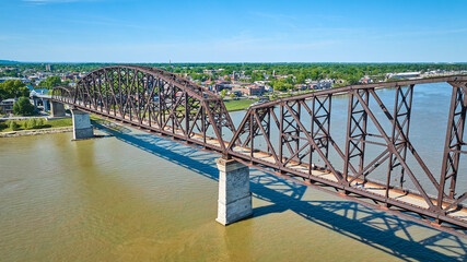 Aerial of brown or rusty red bridge over murky brown river water, Ohio River Louisville Kentucky