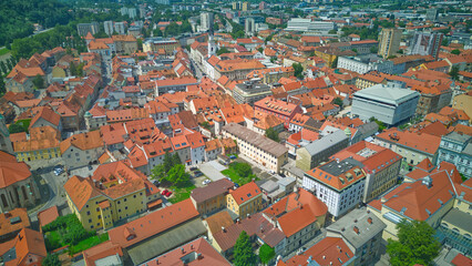 Fototapeta na wymiar City of Celje in Slovenia, Styria, aerial view on the city scape. Amazing landscape with town in Lasko valley, river Savinja and blue sky in the summer.
