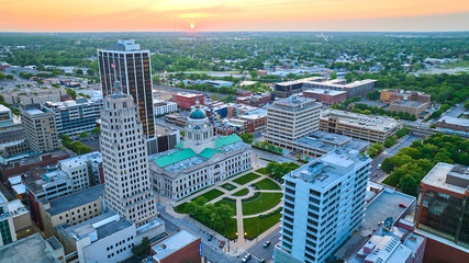 Fototapeta na wymiar Sunrise over heart of downtown Fort Wayne with main office buildings aerial