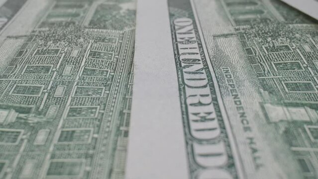 Detailed American banknotes macro slide dolly shot. Fiat money. Money macro shot on Probe lens.Close-up of one hundred dollar bills. 4K, UHD
