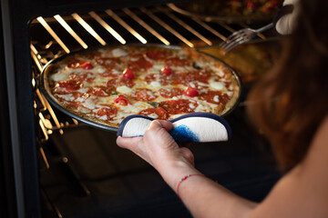 Woman cooking a tomato pizza