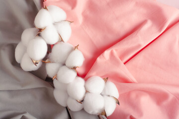 Cotton branch on green and pink crumpled fabric