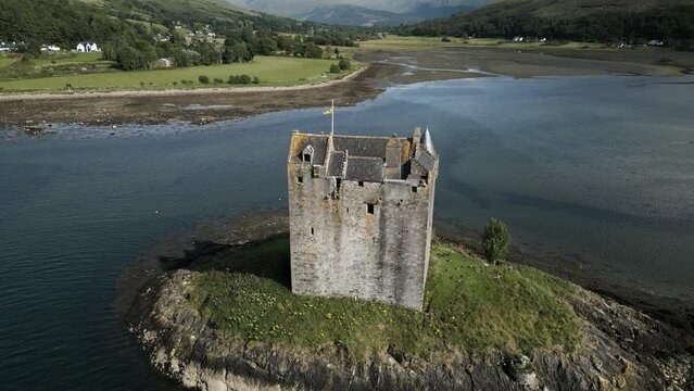 Aerial drone shots of Medieval castle surrounded by water on the east coast of Scotland in Argyll, UK.