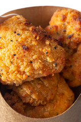 Southern fried chicken bites takeaway in a cardboard tray with a wooden fork. Biodegradable plastic free eco friendly takeaway container