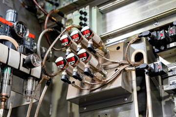 Electronic and mechanical control system for the hydraulics of a CNC machine.