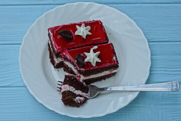 delicious fresh red  color with white and brown  cream fragrant sweet sliced cake from a pastry...
