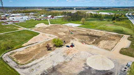 Construction sand piles gravel mound, dirt ground up muddy mess aerial