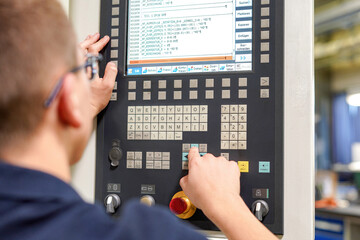 The CNC milling machine programmer makes adjustments to the program to change the cutting...