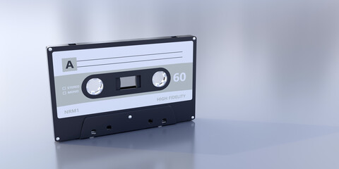 Retro audio cassette tape with blank label on grey background