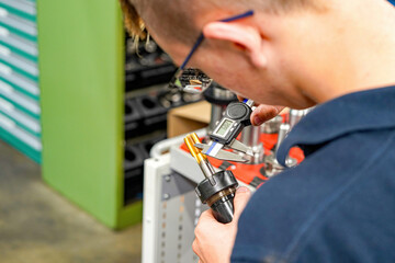 Checking the dimensions of the cutting tool with a caliper for metalworking CNC milling and turning...